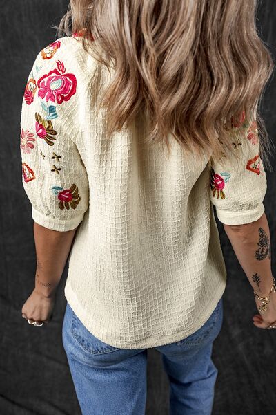Floral embroidered notched puff sleeve blouse.
