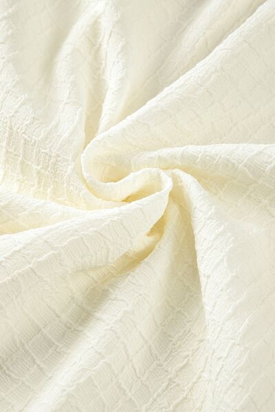 Floral embroidered notched puff sleeve blouse.