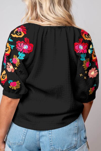 Floral embroidered notched puff sleeve blouse.