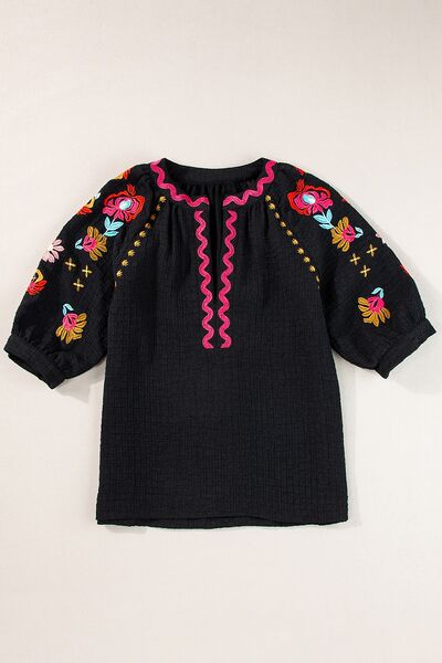 Floral embroidered notched puff sleeve blouse.