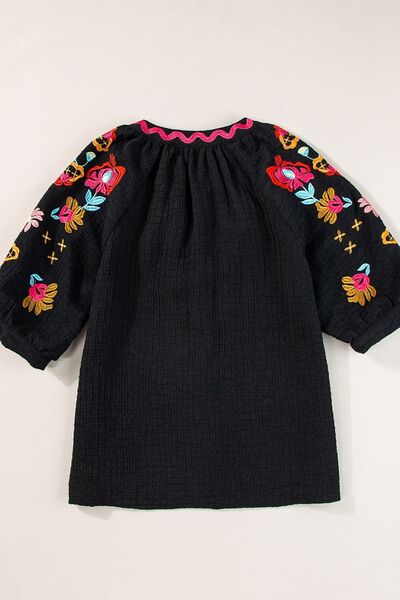 Floral embroidered notched puff sleeve blouse.