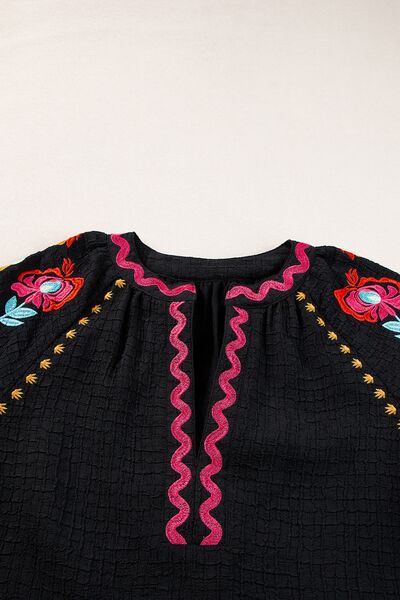 Floral embroidered notched puff sleeve blouse.