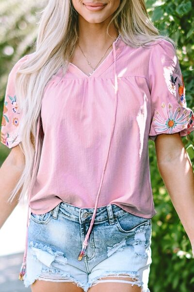 Floral embroidered puff sleeve blouse.