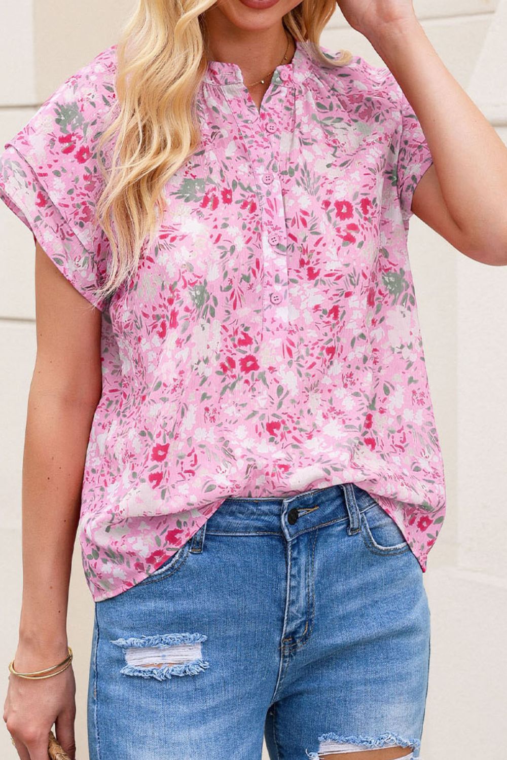 Floral half button round neck short sleeve blouse.