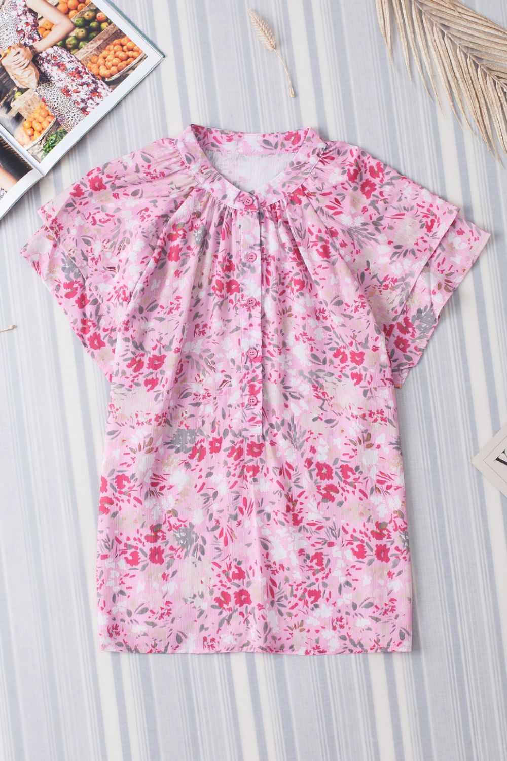 Floral half button round neck short sleeve blouse.