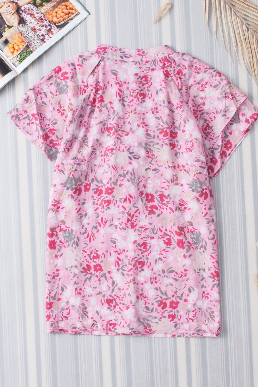 Floral half button round neck short sleeve blouse.
