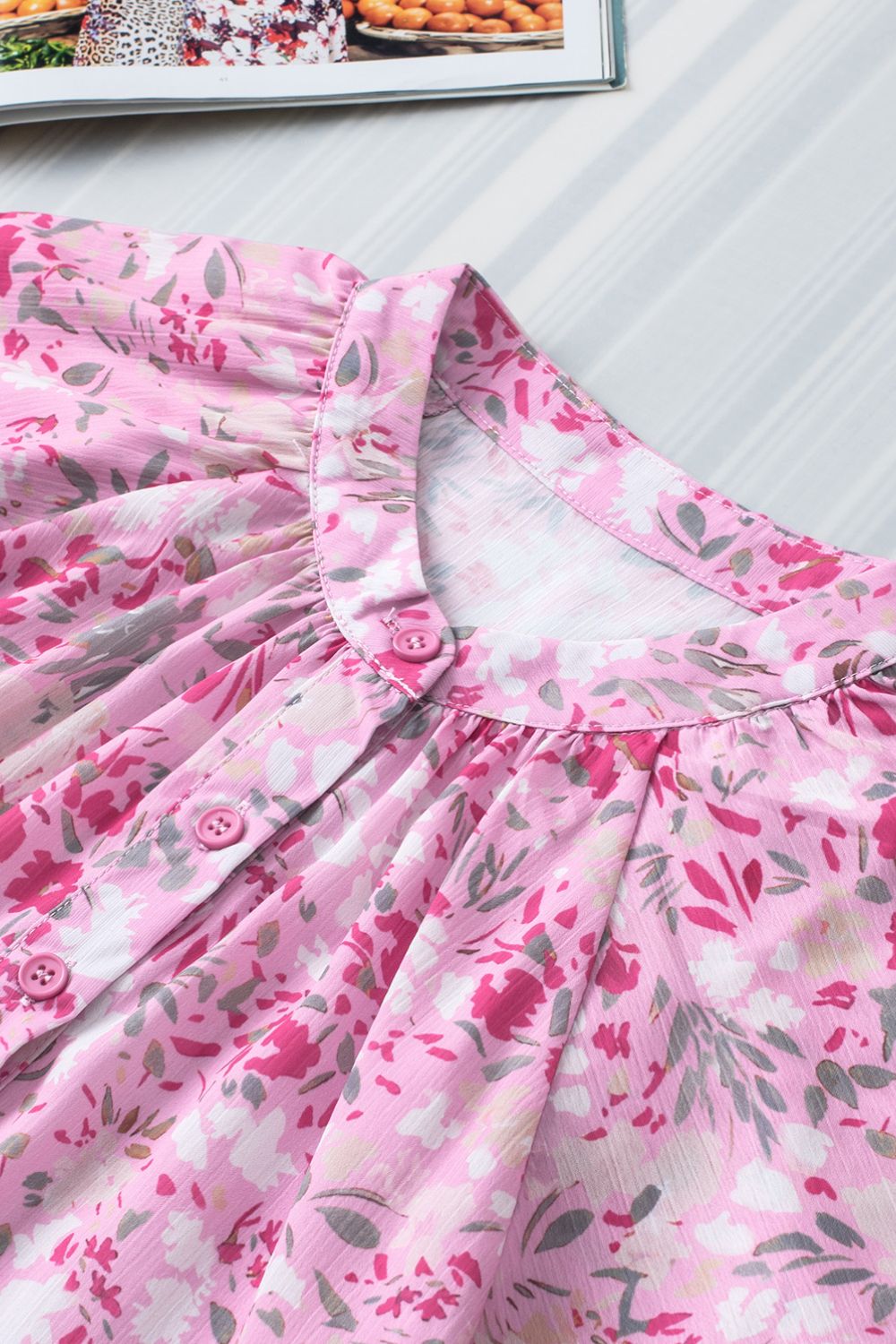 Floral half button round neck short sleeve blouse.