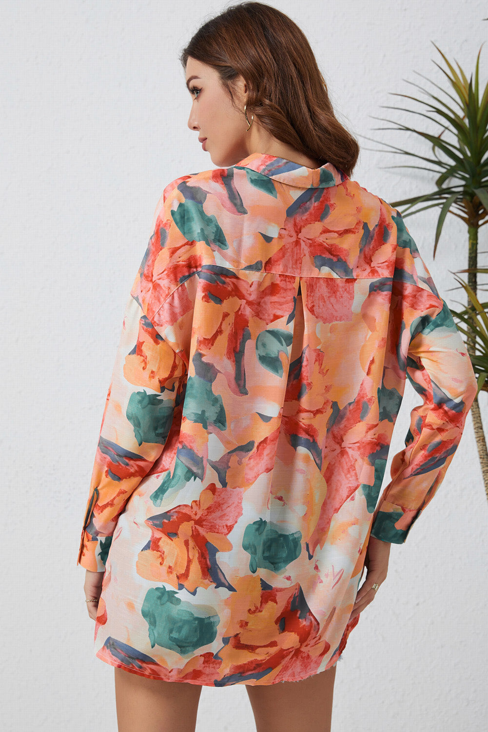 Floral long sleeve slit longline shirt with pockets.