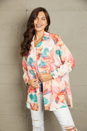Floral long sleeve slit longline shirt with pockets.