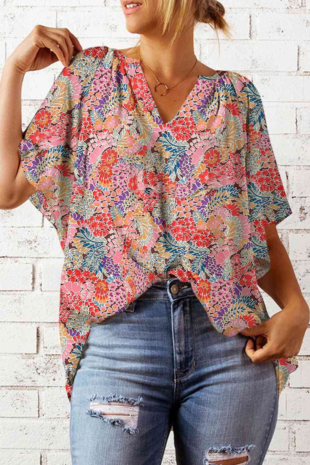Floral notched neck flutter sleeve blouse.
