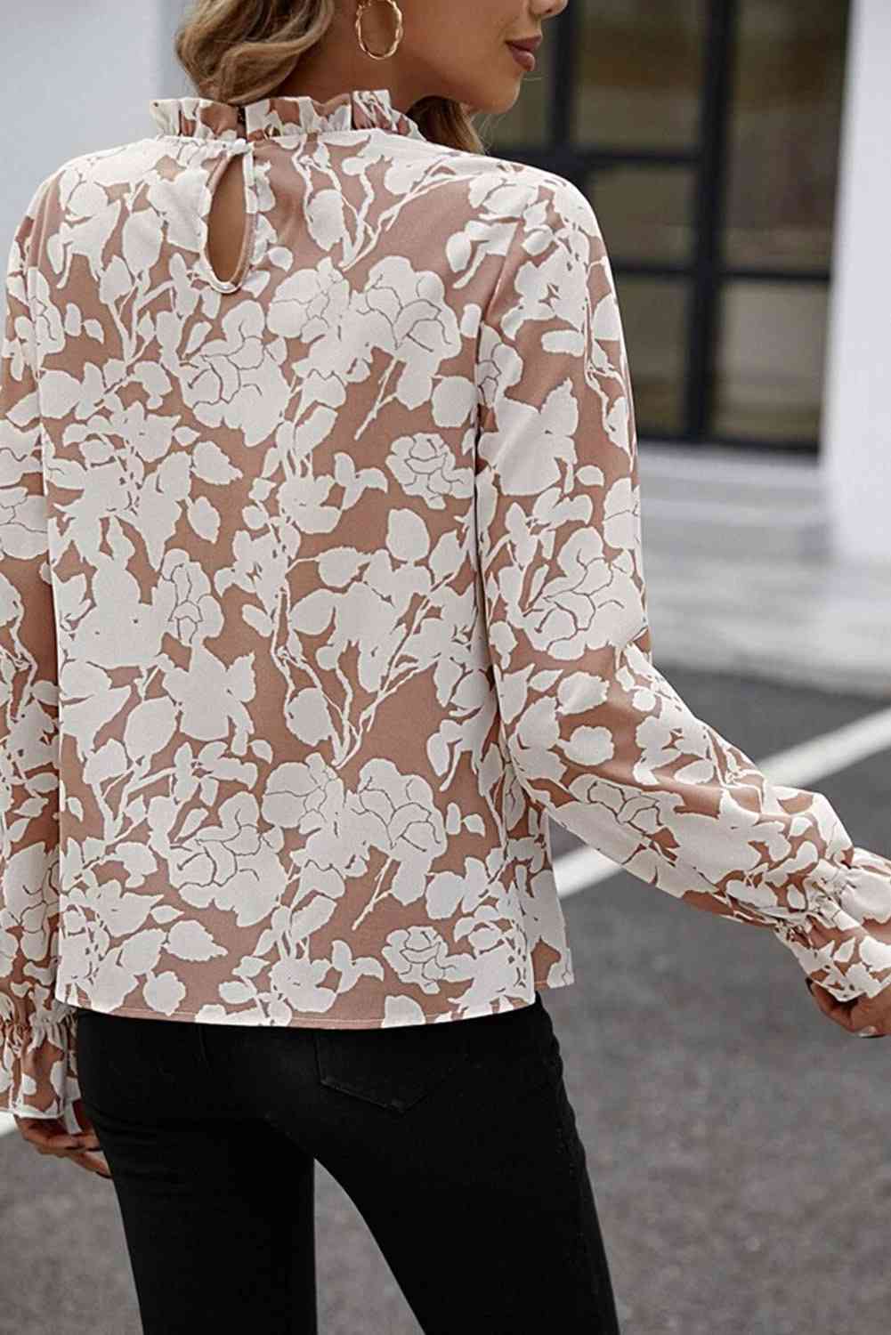 Floral print mock neck flounce sleeve blouse with ruffles.
