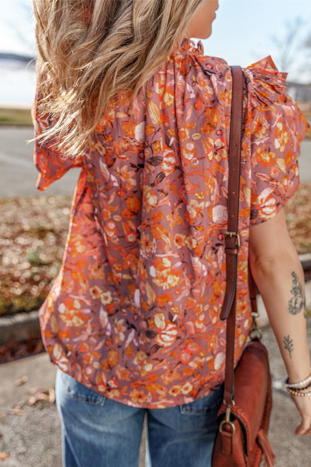 Floral ruffled layered short sleeve tie neck blouse with frill.