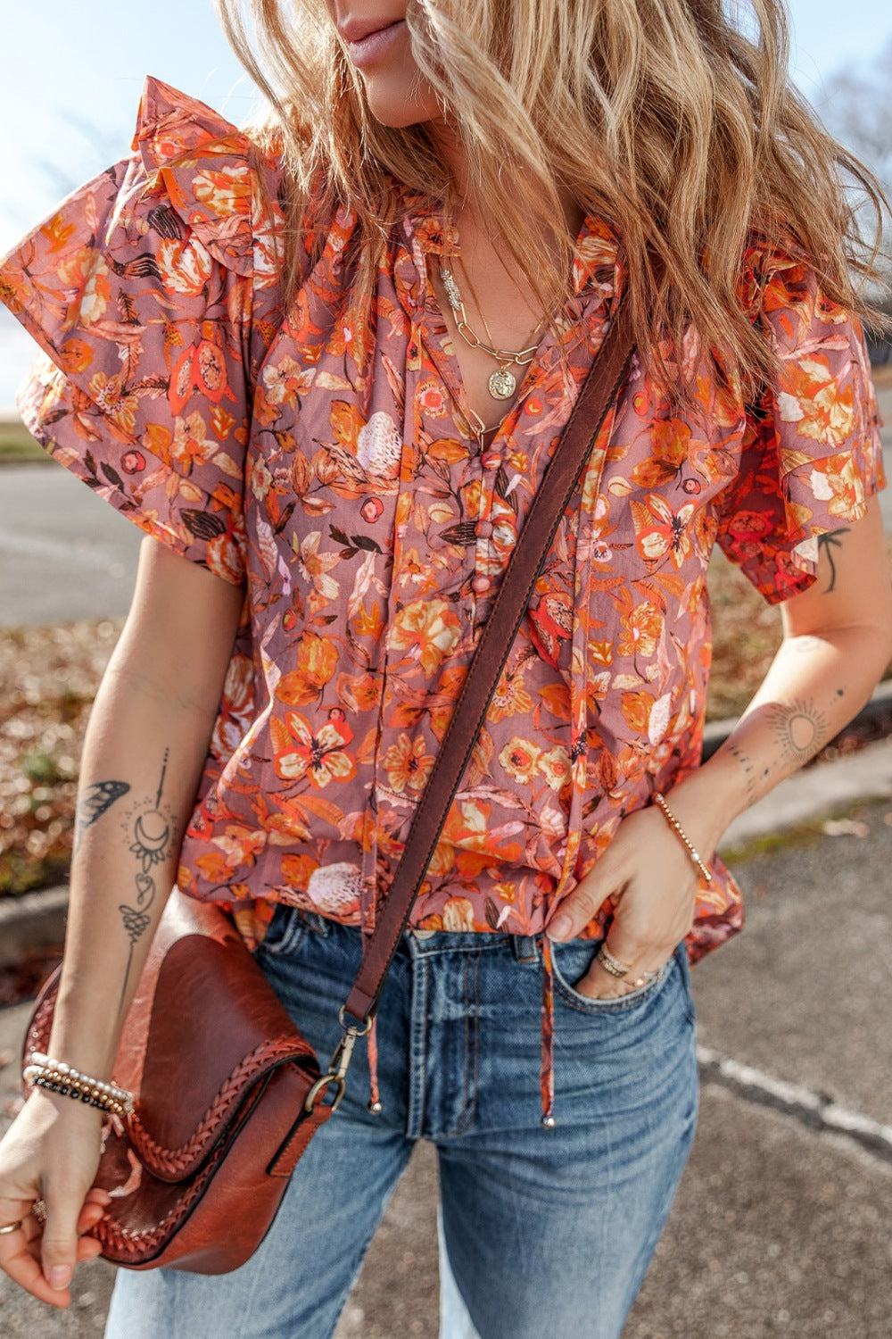 Floral ruffled layered short sleeve tie neck blouse with frill.