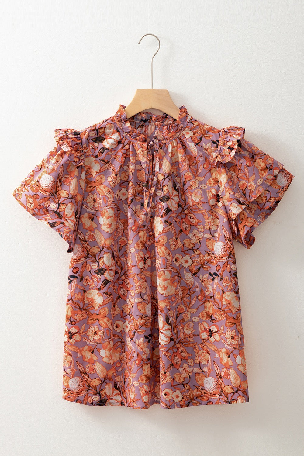 Floral ruffled layered short sleeve tie neck blouse with frill.