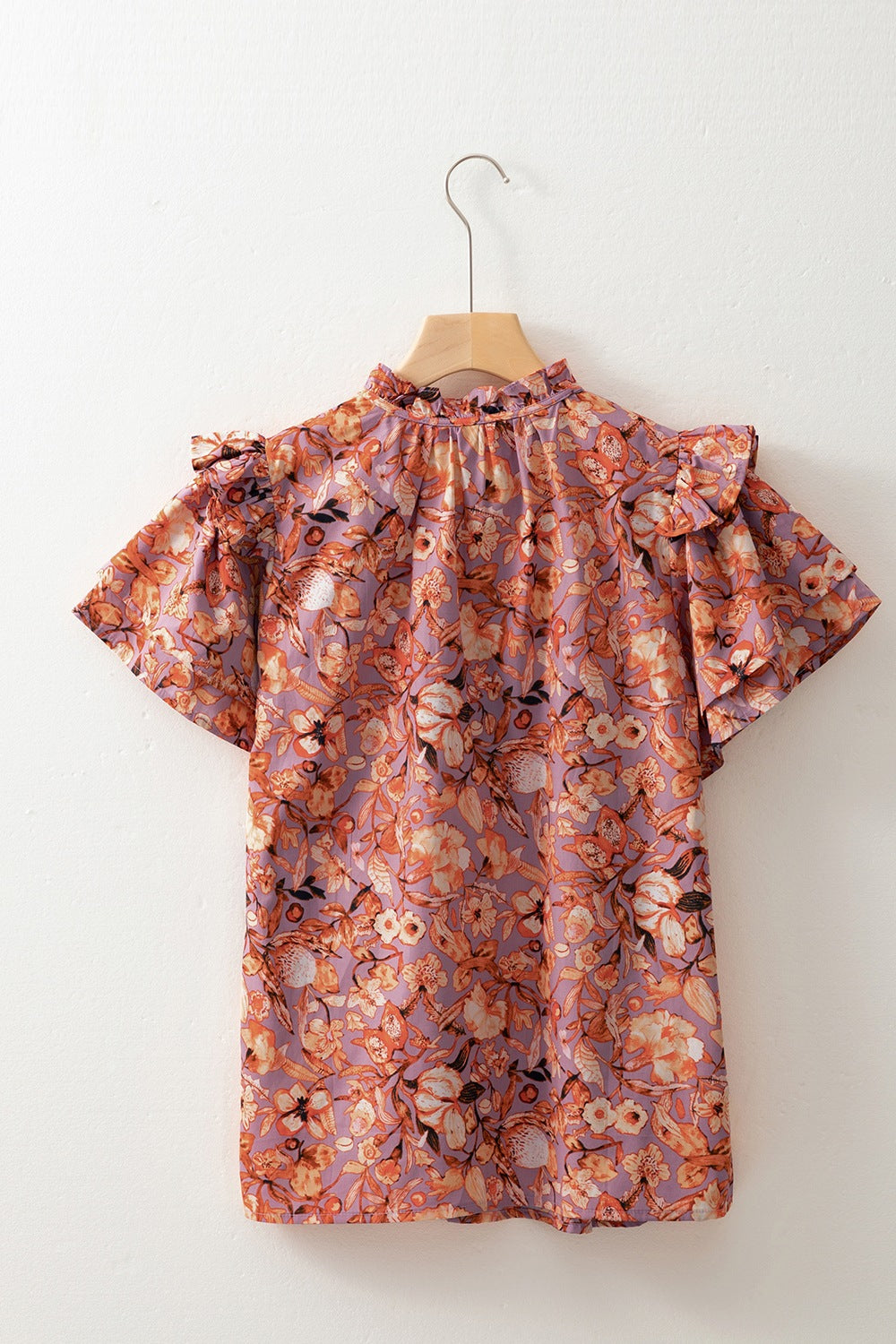 Floral ruffled layered short sleeve tie neck blouse with frill.