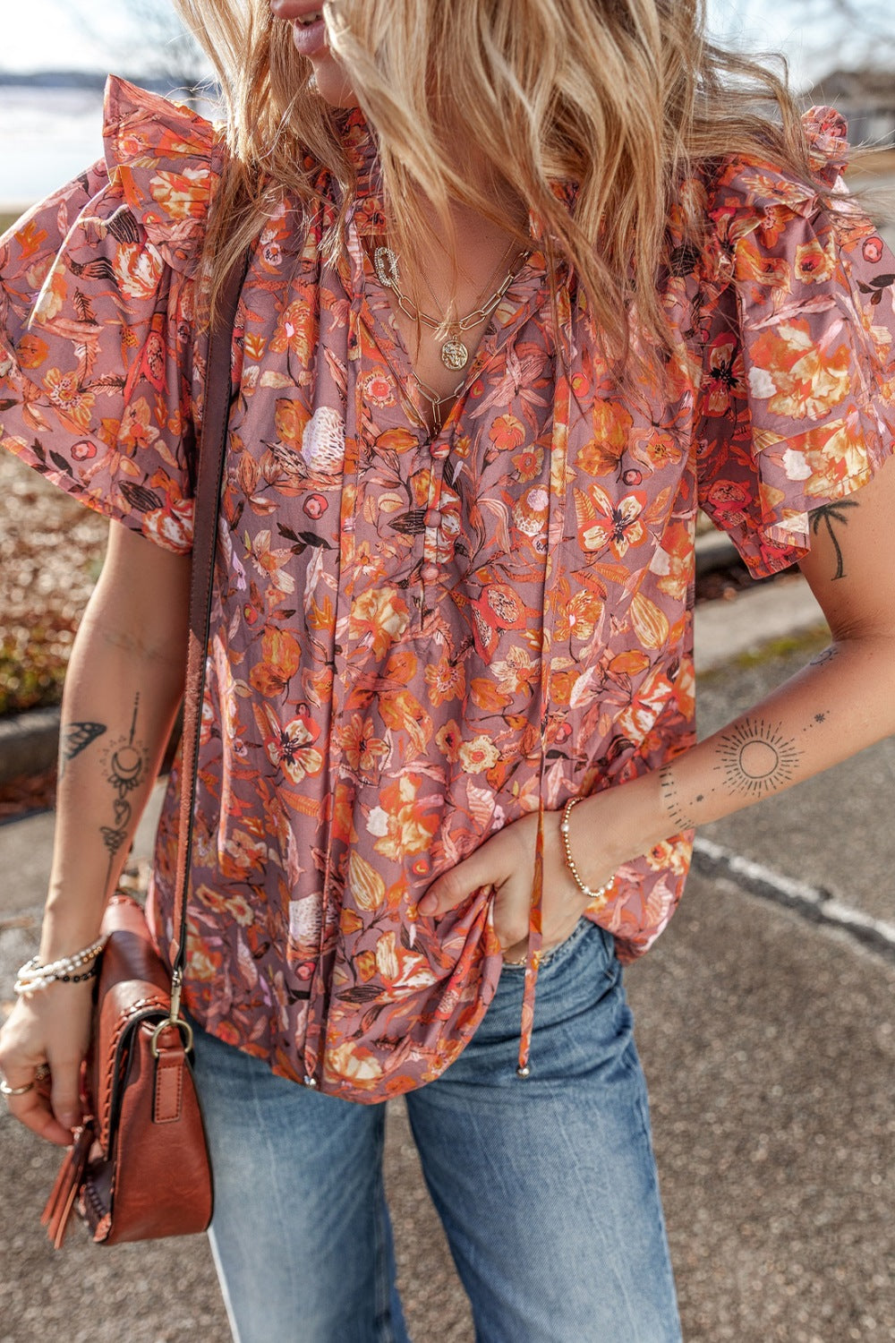 Floral ruffled layered short sleeve tie neck blouse with frill.