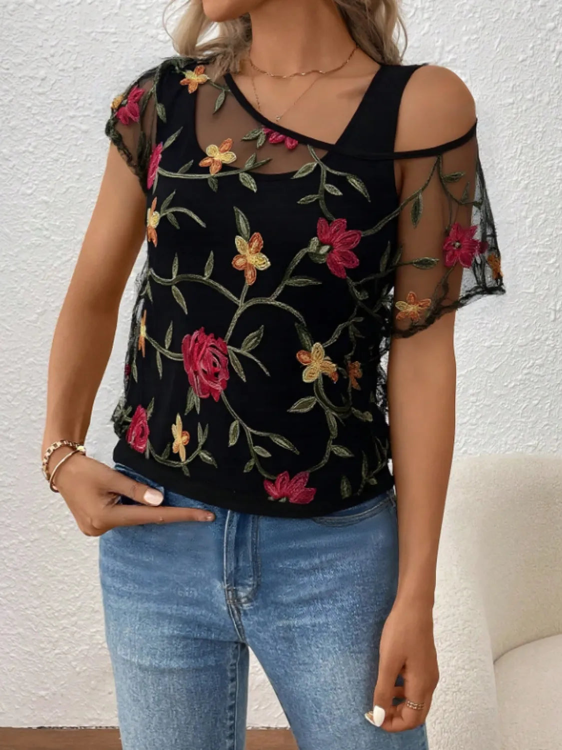 Floral short sleeve sheer top.