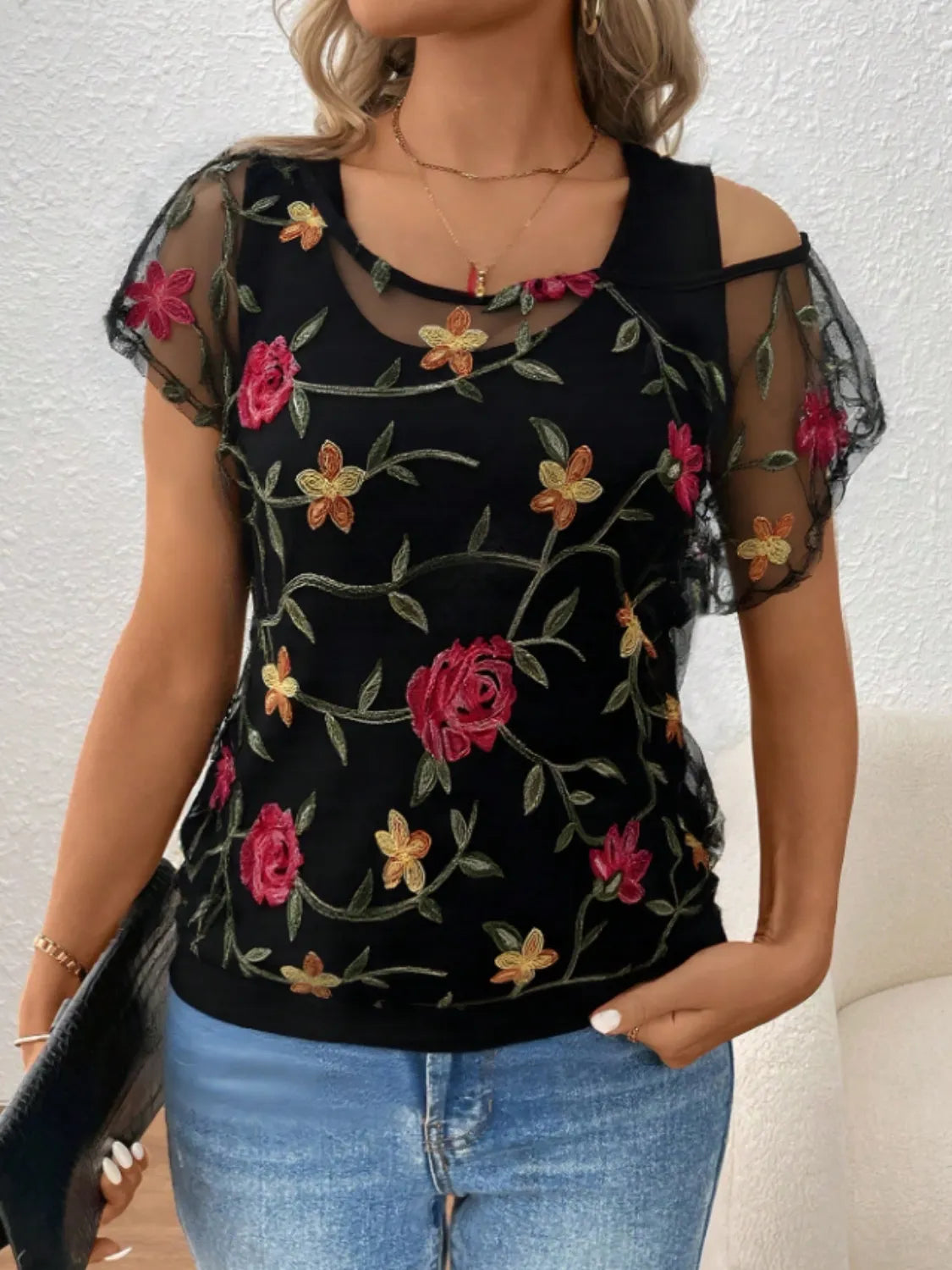 Floral short sleeve sheer top.