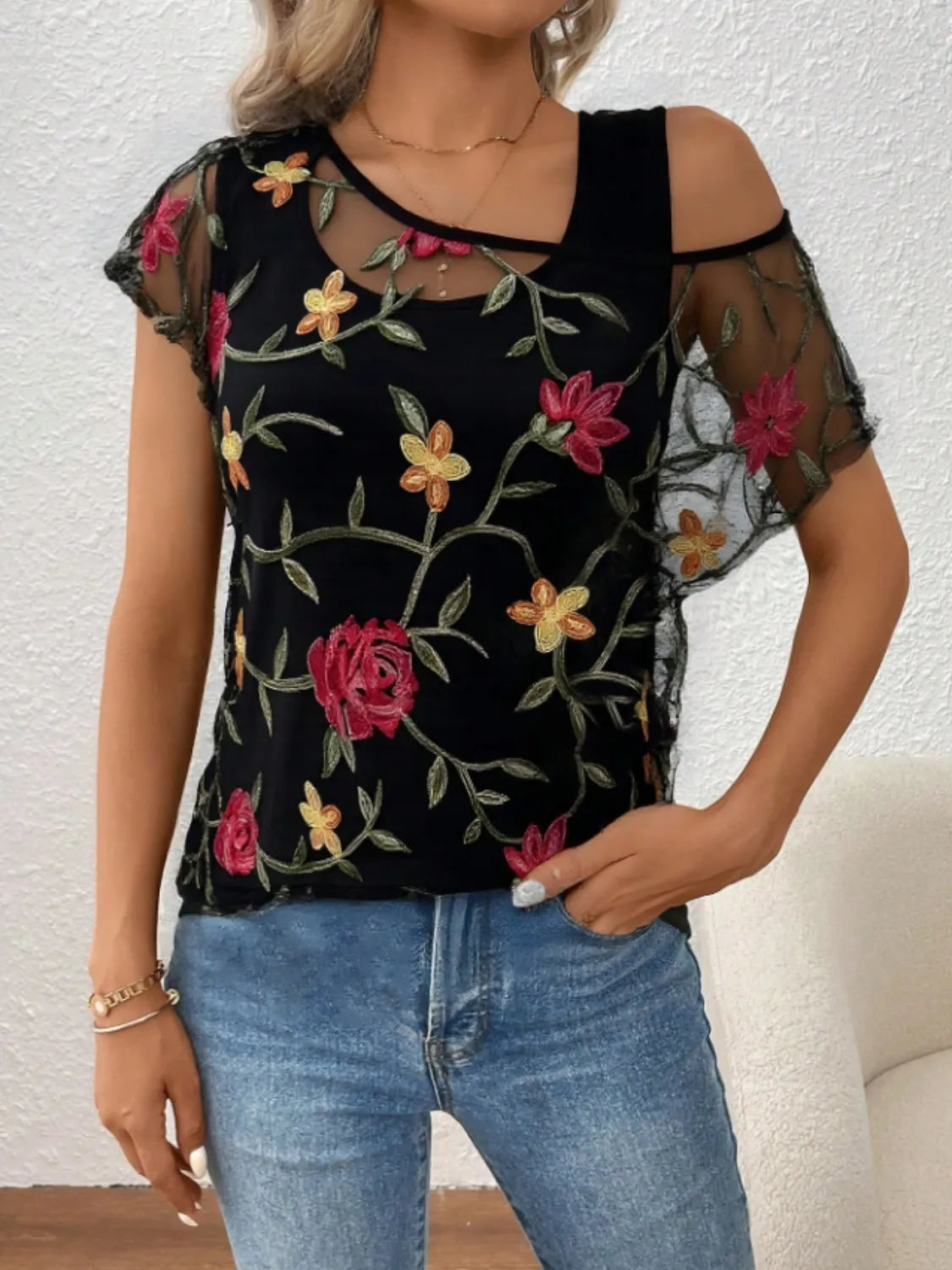 Floral short sleeve sheer top.
