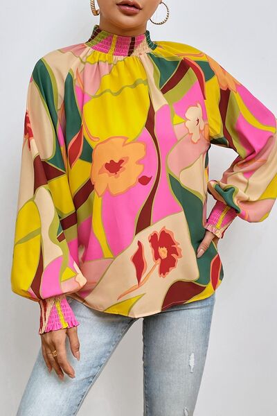 Floral smocked lantern sleeve mock neck blouse.