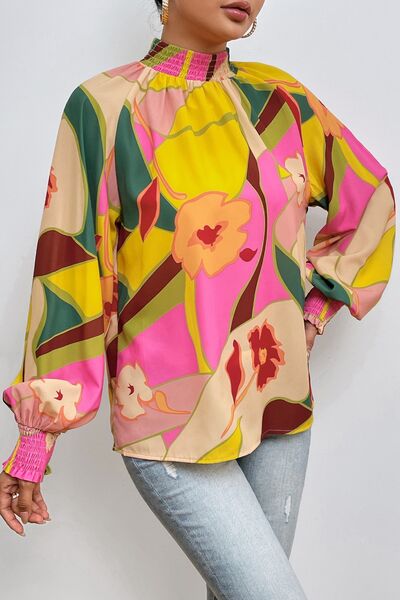 Floral smocked lantern sleeve mock neck blouse.