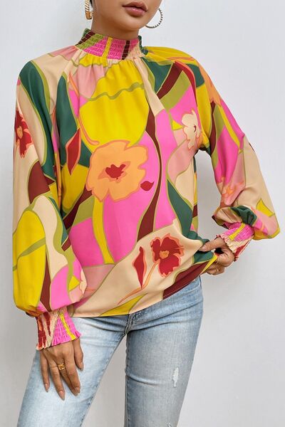 Floral smocked lantern sleeve mock neck blouse.