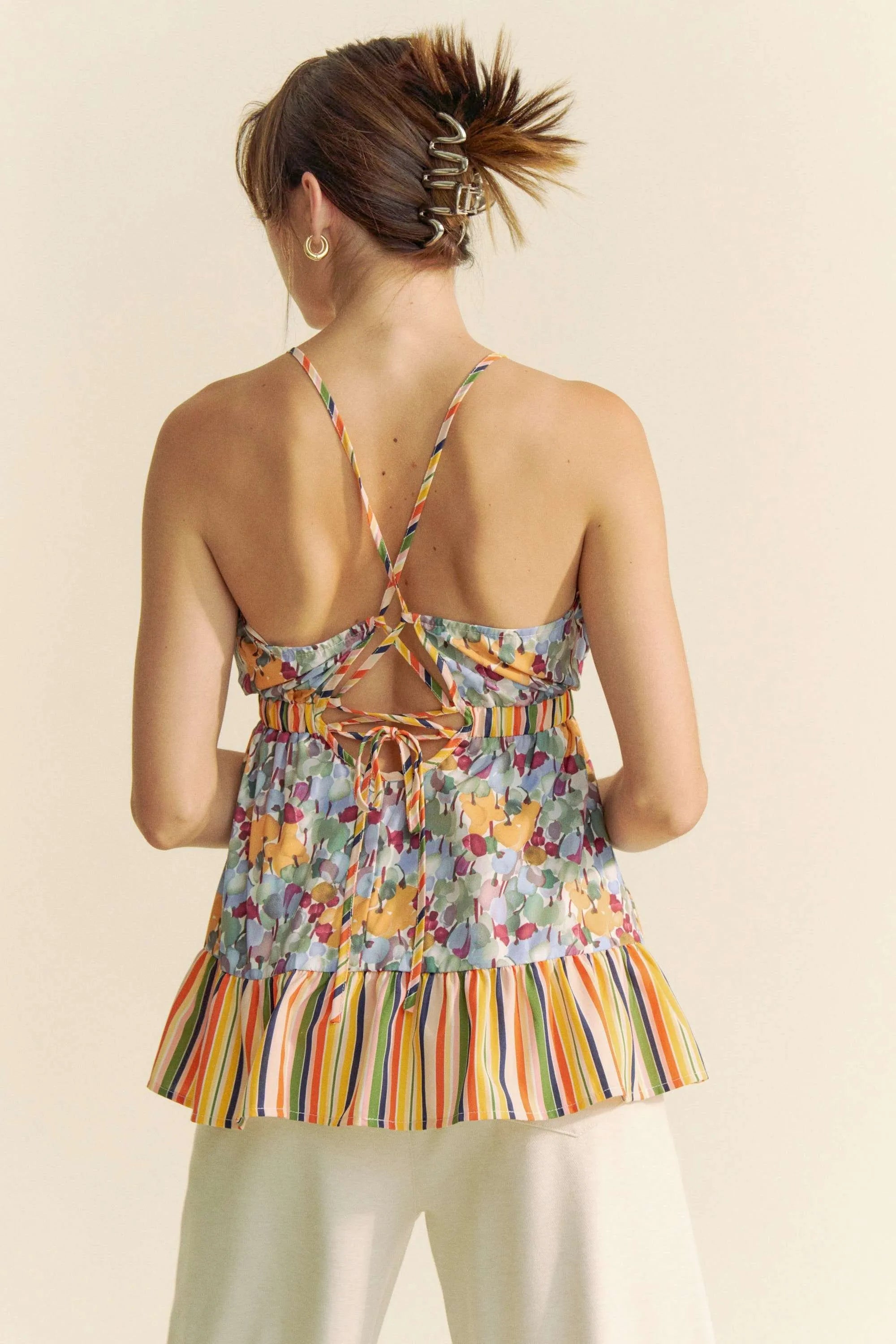 Floral smocked sleeveless top with ruffle and back tie.