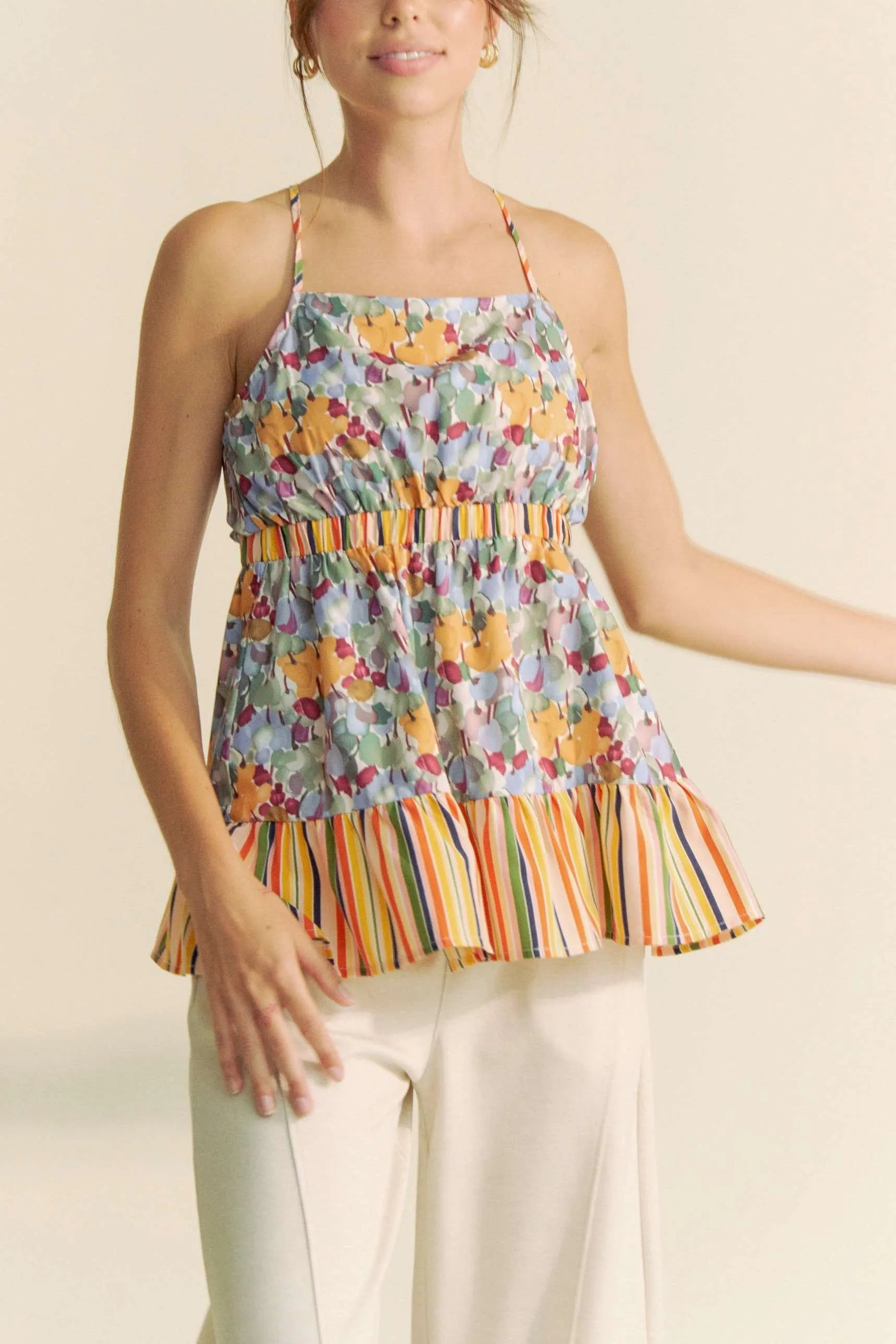 Floral smocked sleeveless top with ruffle and back tie.