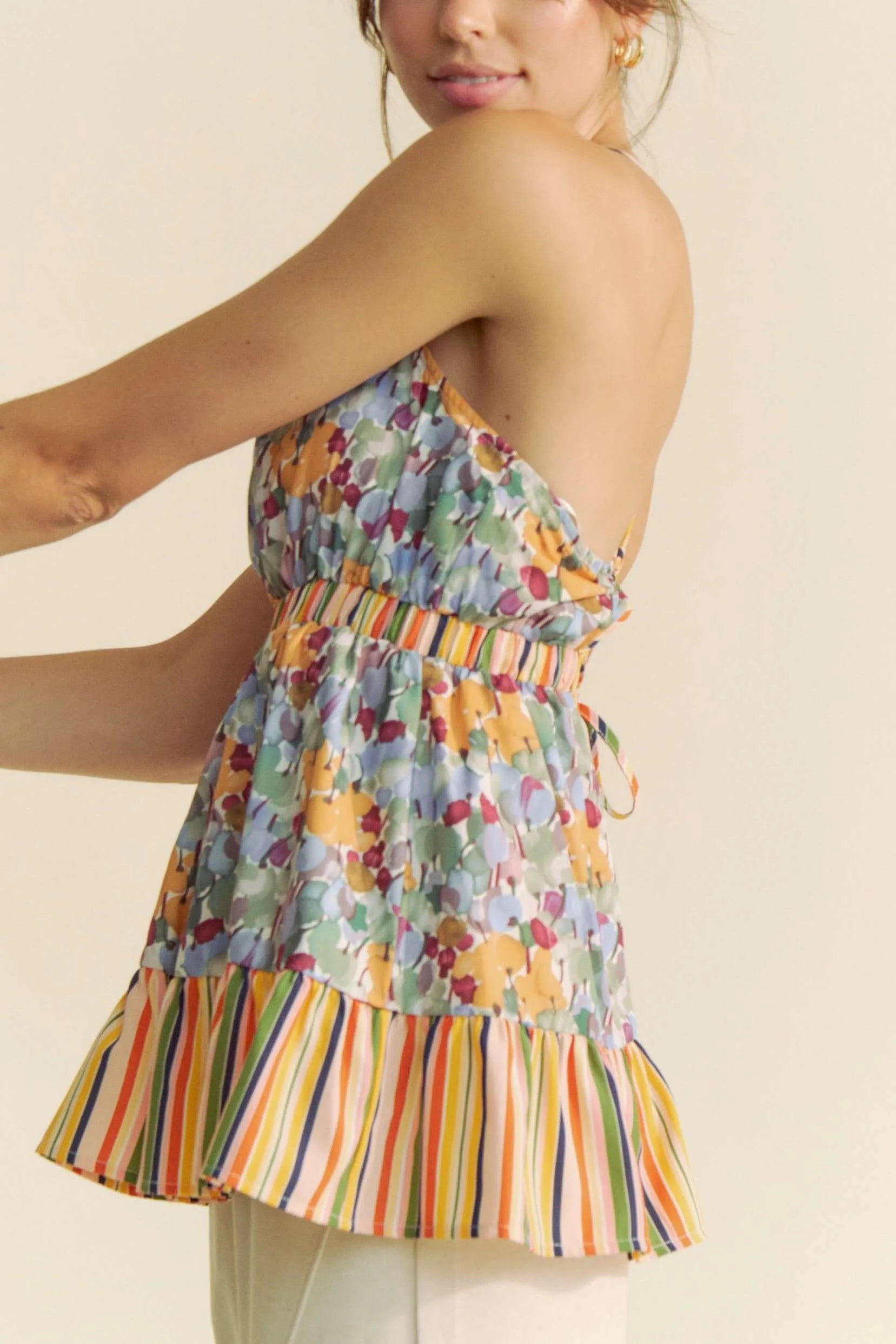 Floral smocked sleeveless top with ruffle and back tie.