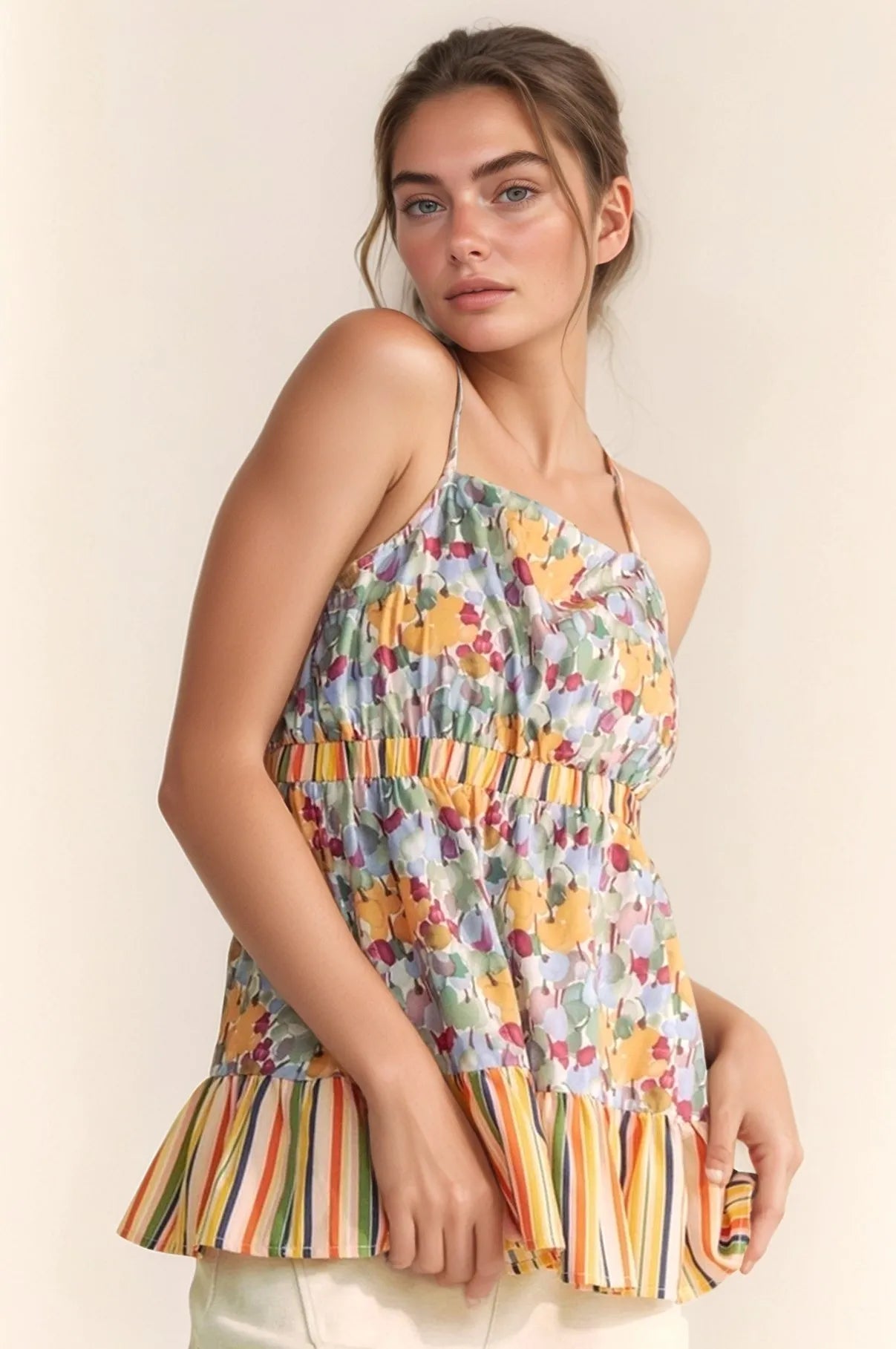 Floral smocked sleeveless top with ruffle and back tie.