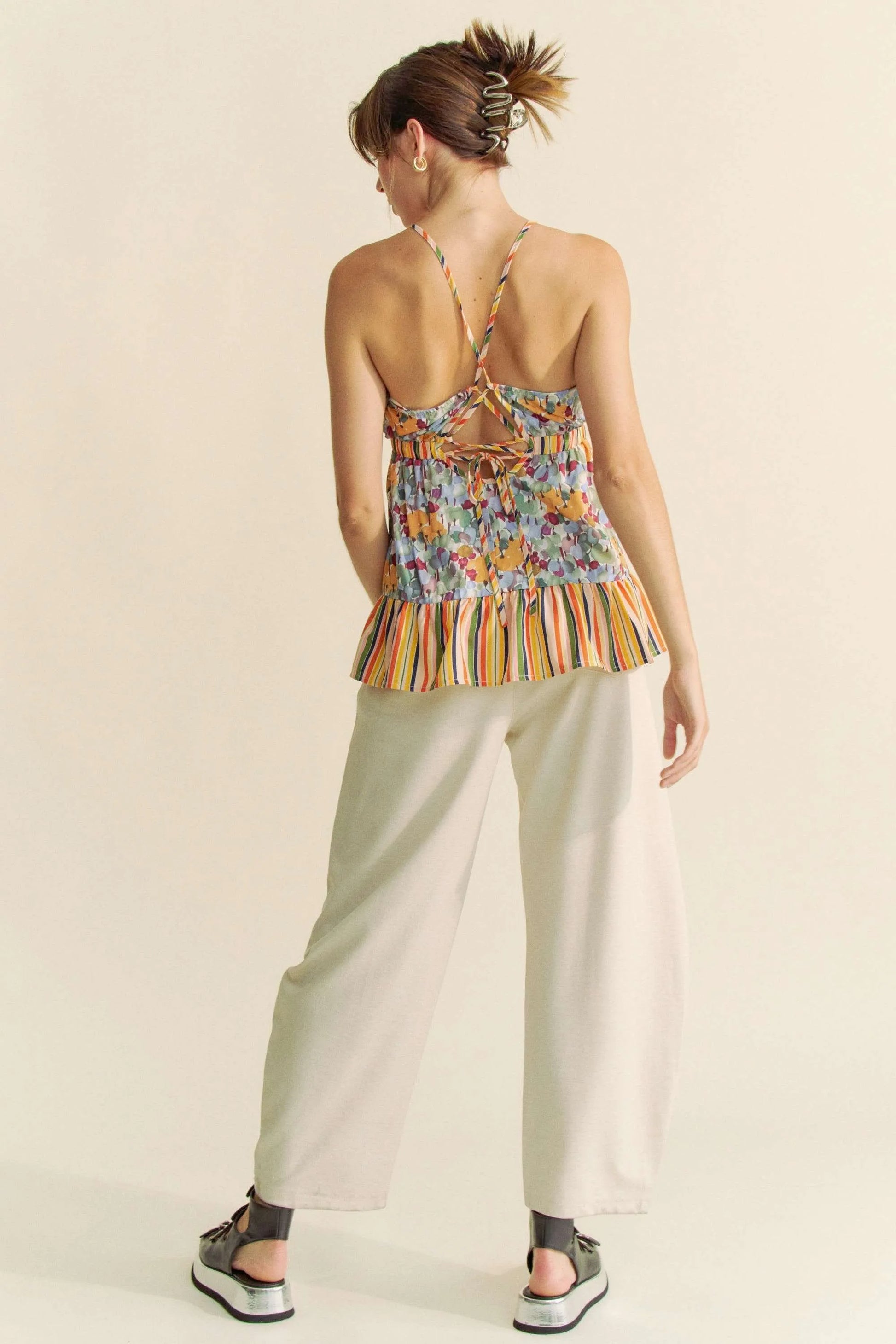Floral smocked sleeveless top with ruffle and back tie.