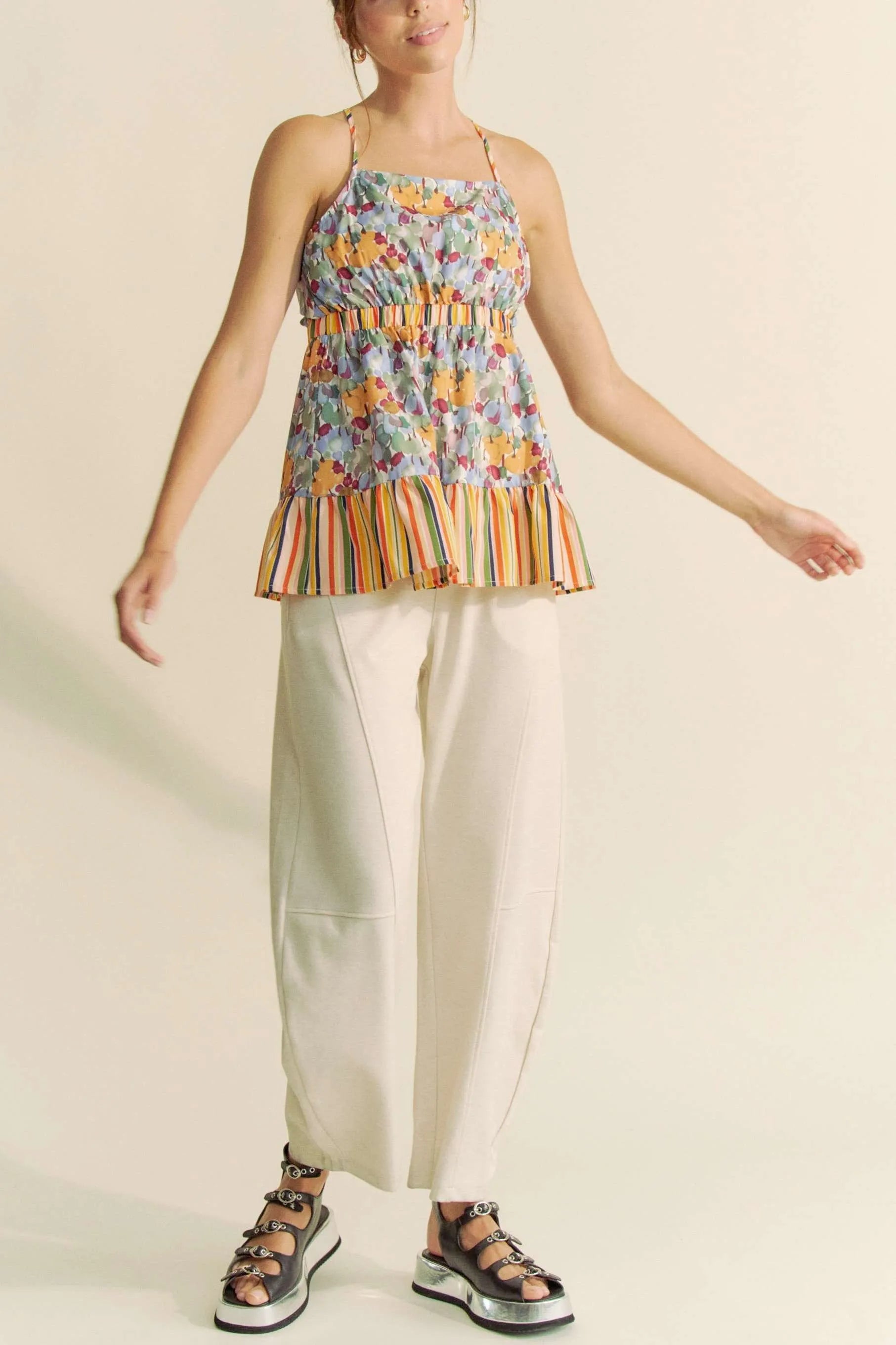 Floral smocked sleeveless top with ruffle and back tie.