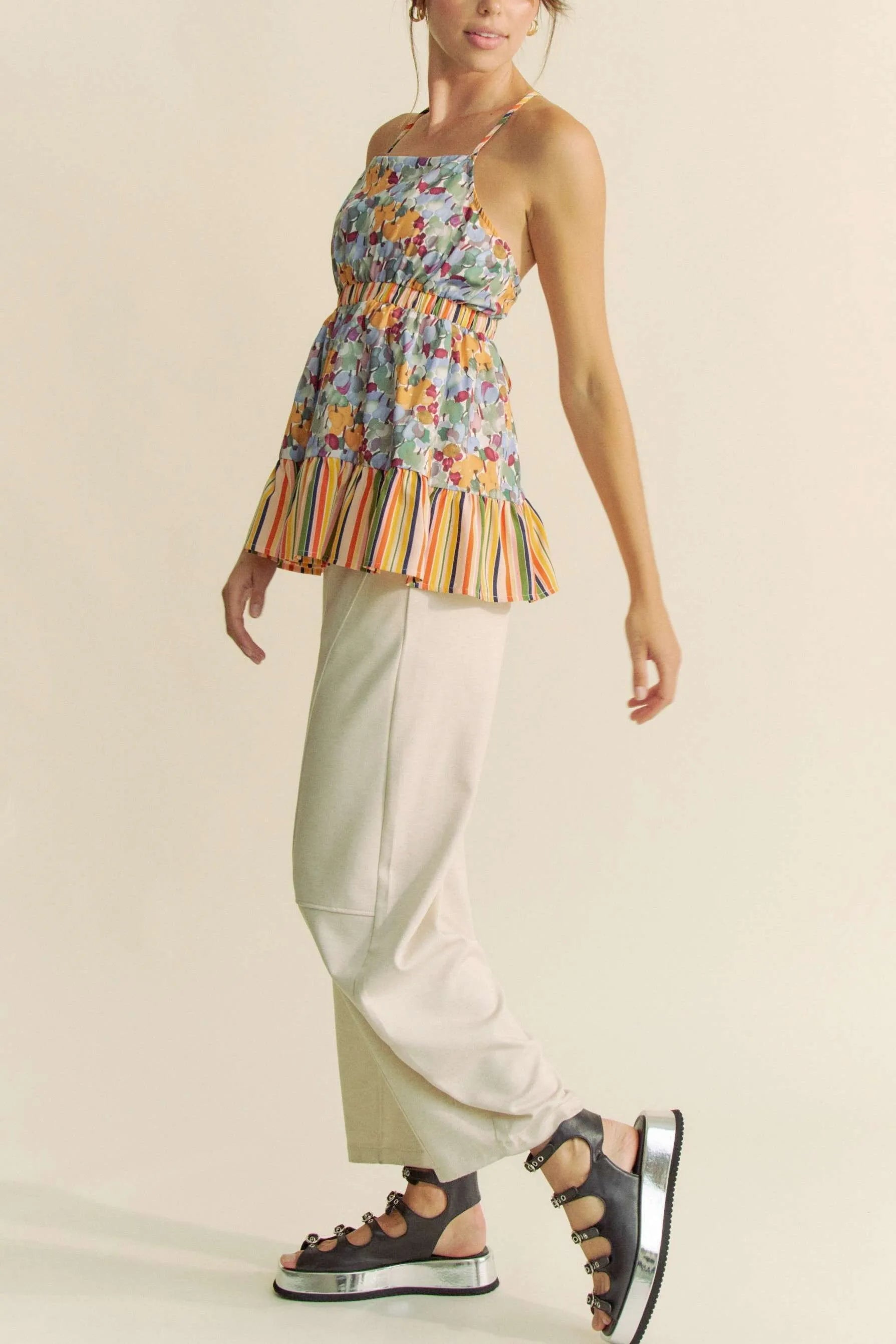 Floral smocked sleeveless top with ruffle and back tie.