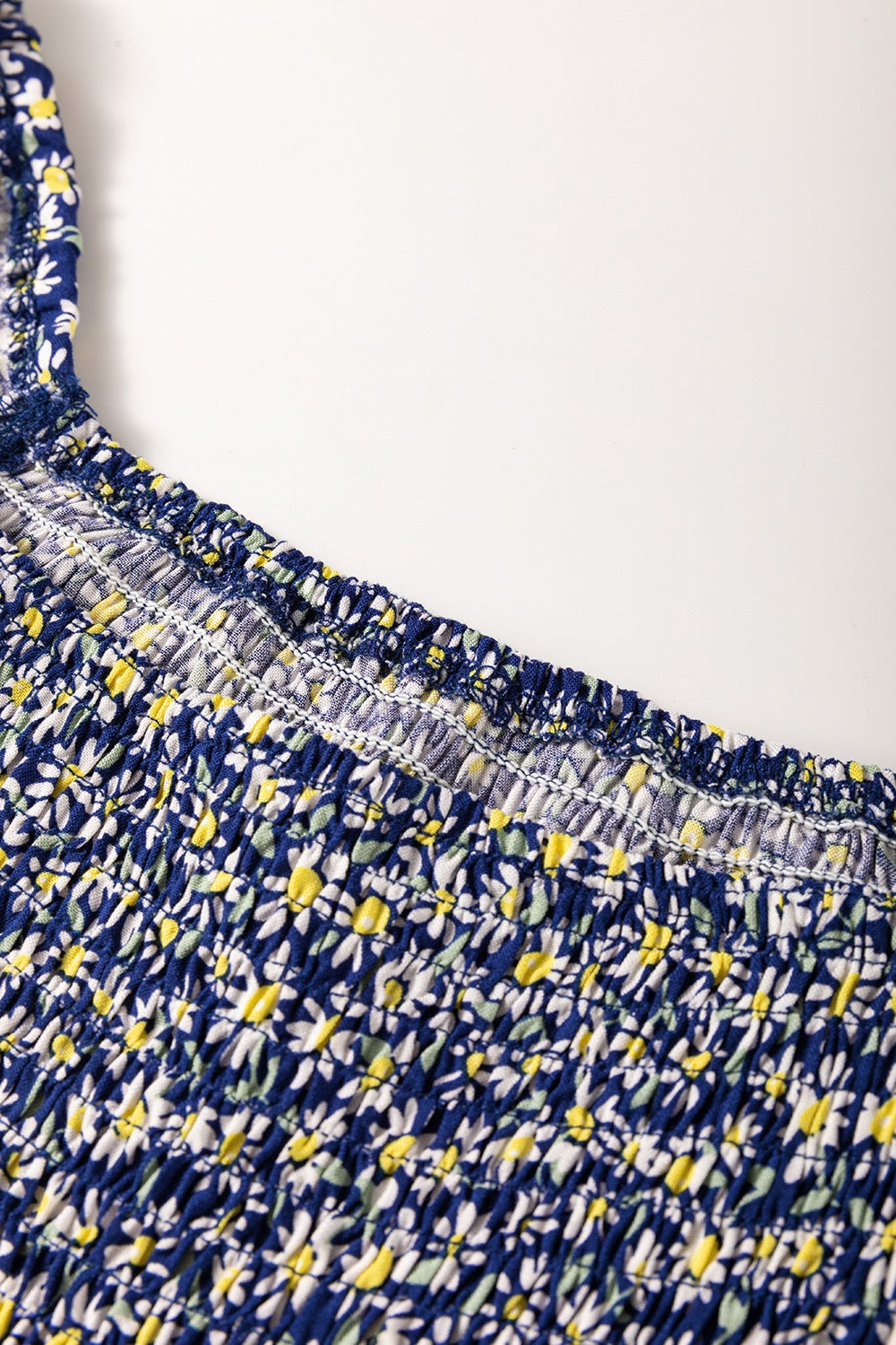 Floral smocked square neck blouse.