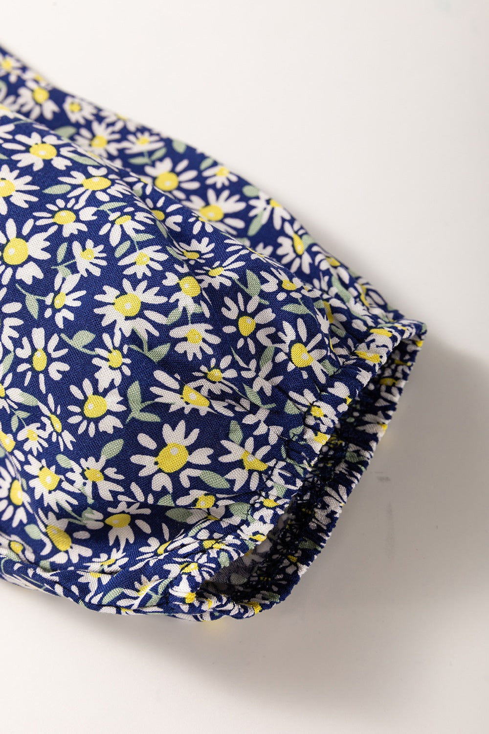 Floral smocked square neck blouse.