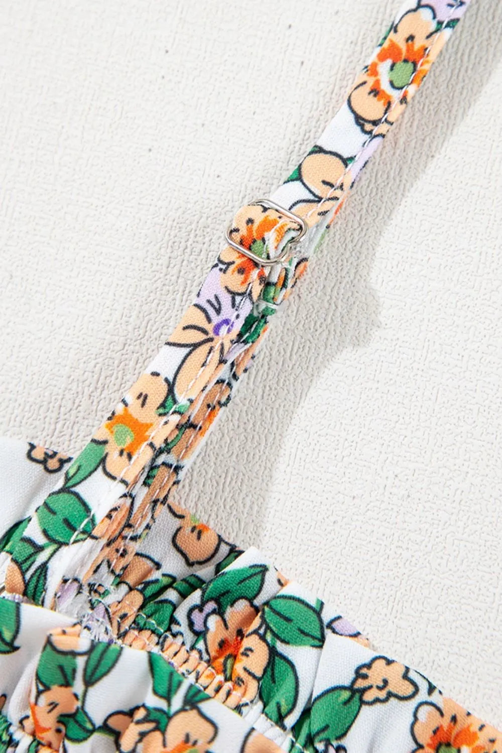 Floral spaghetti strap ruffled cami with layered design.