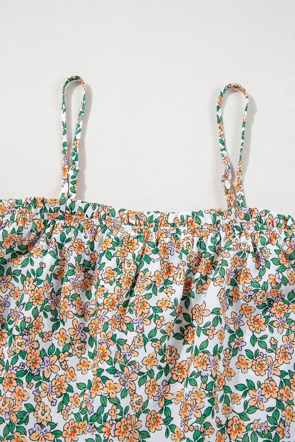 Floral spaghetti strap ruffled cami with layered design.