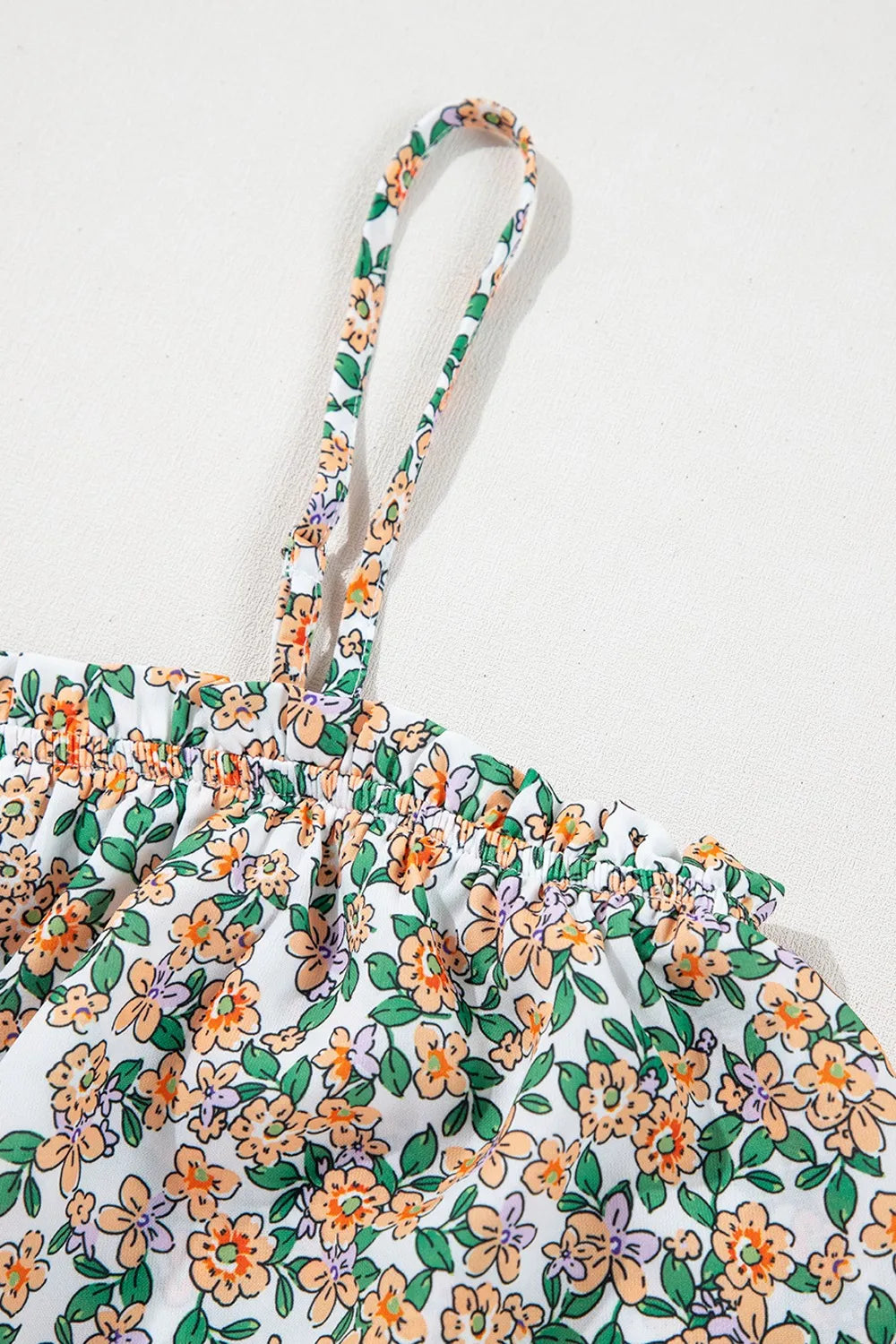 Floral spaghetti strap ruffled cami with layered design.