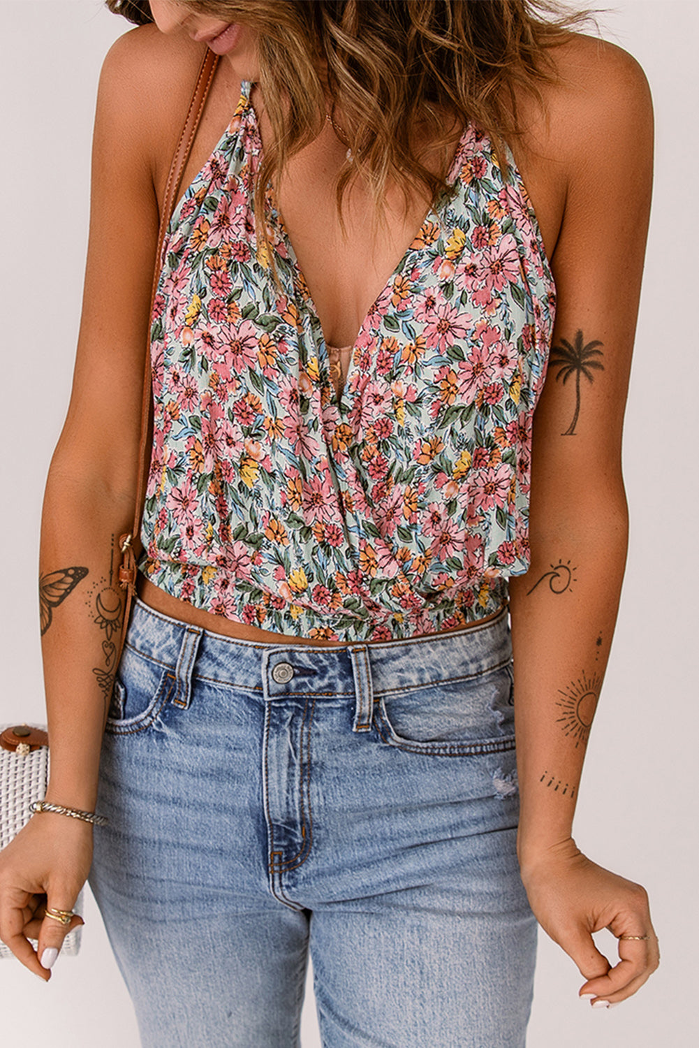 Floral surplice neck sleeveless top.