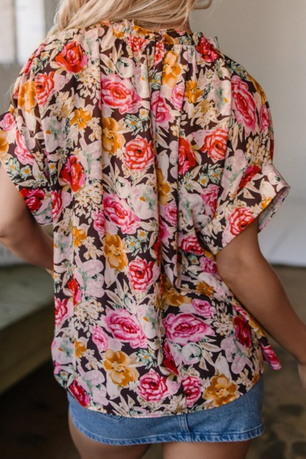 Floral tie neck short sleeve blouse with frill.