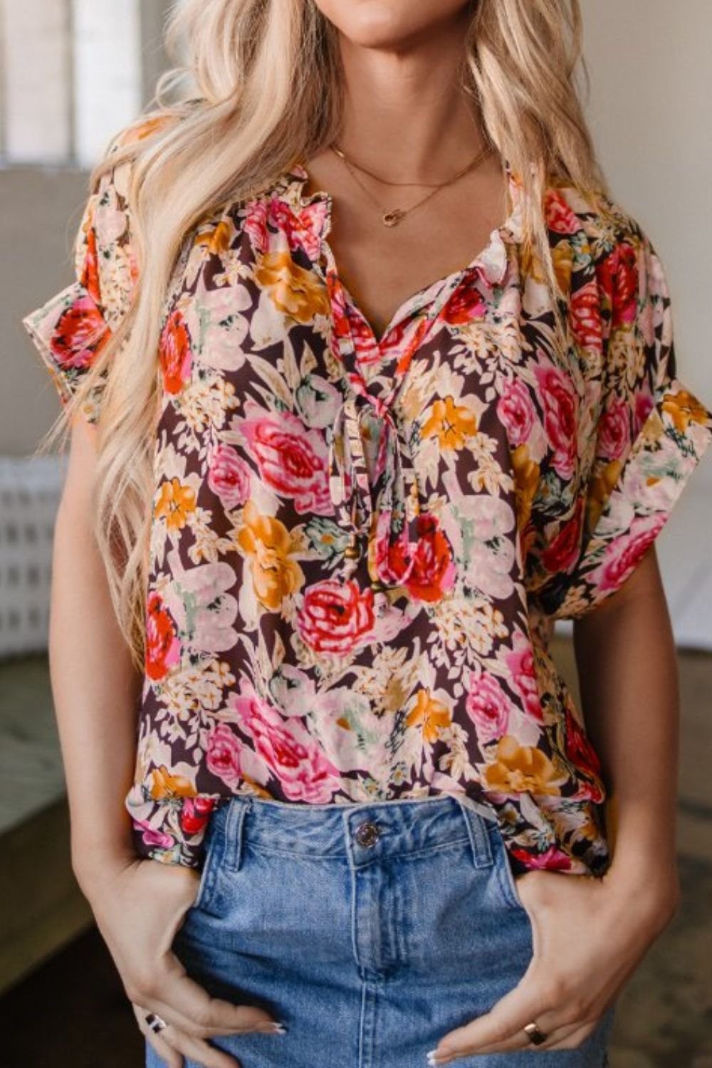 Floral tie neck short sleeve blouse with frill.