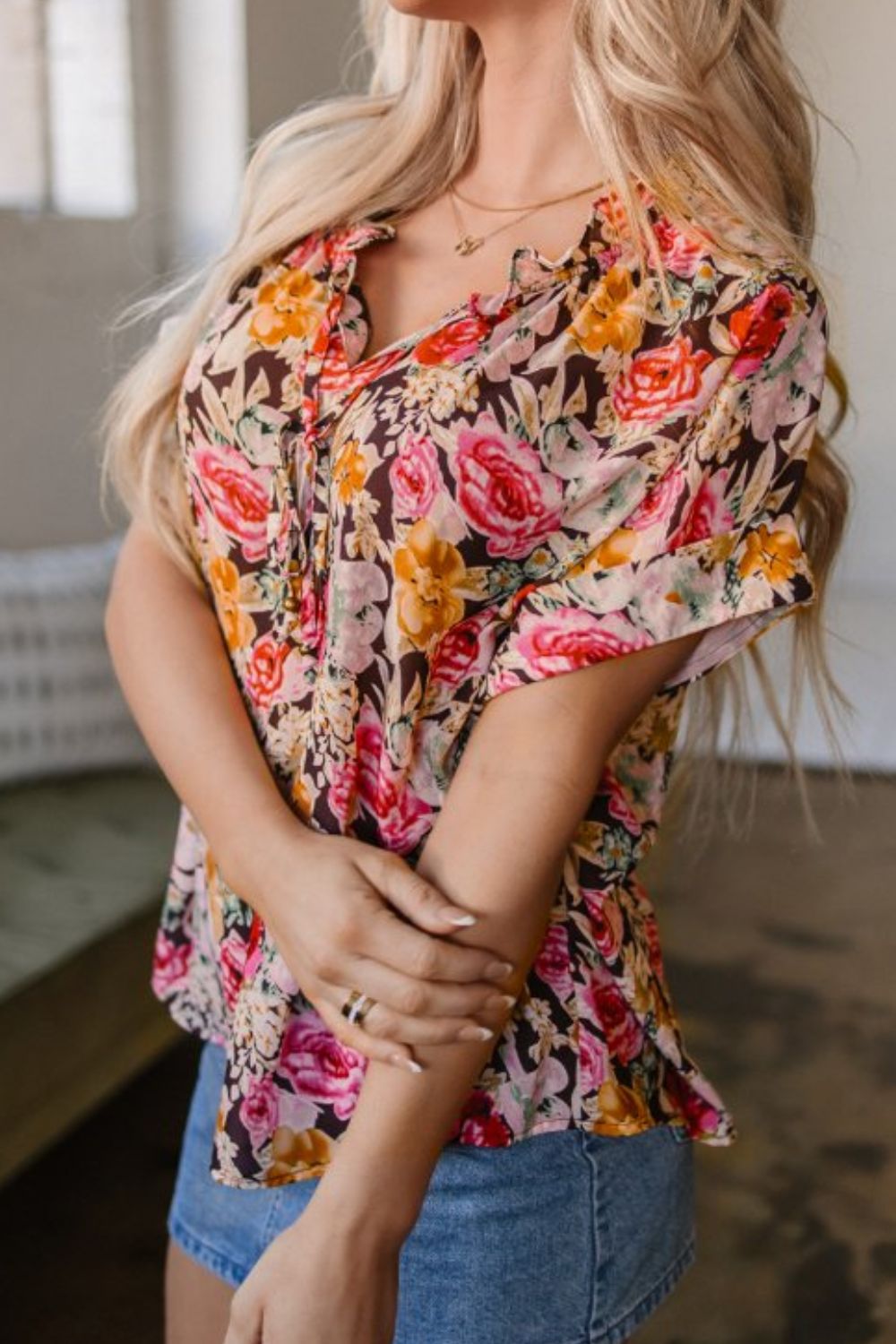 Floral tie neck short sleeve blouse with frill.