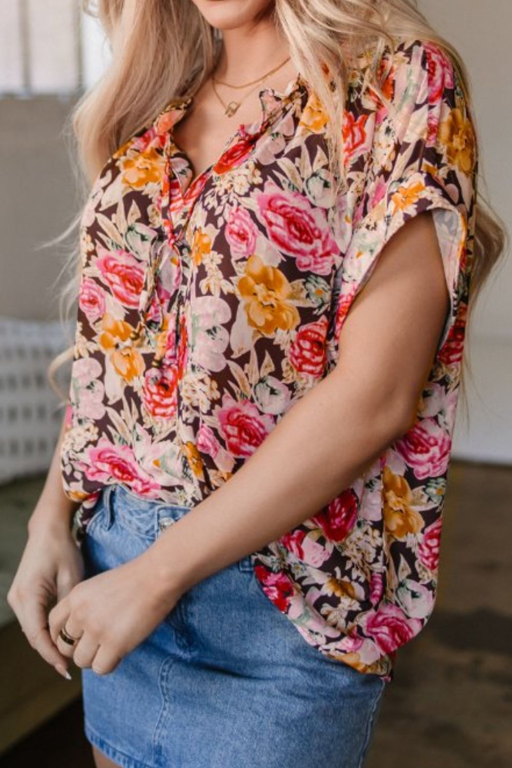 Floral tie neck short sleeve blouse with frill.