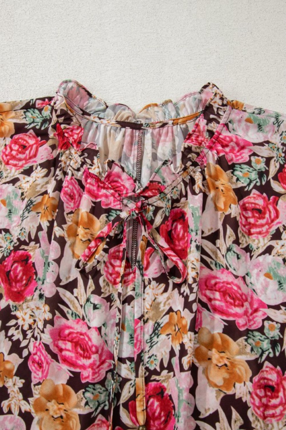 Floral tie neck short sleeve blouse with frill.