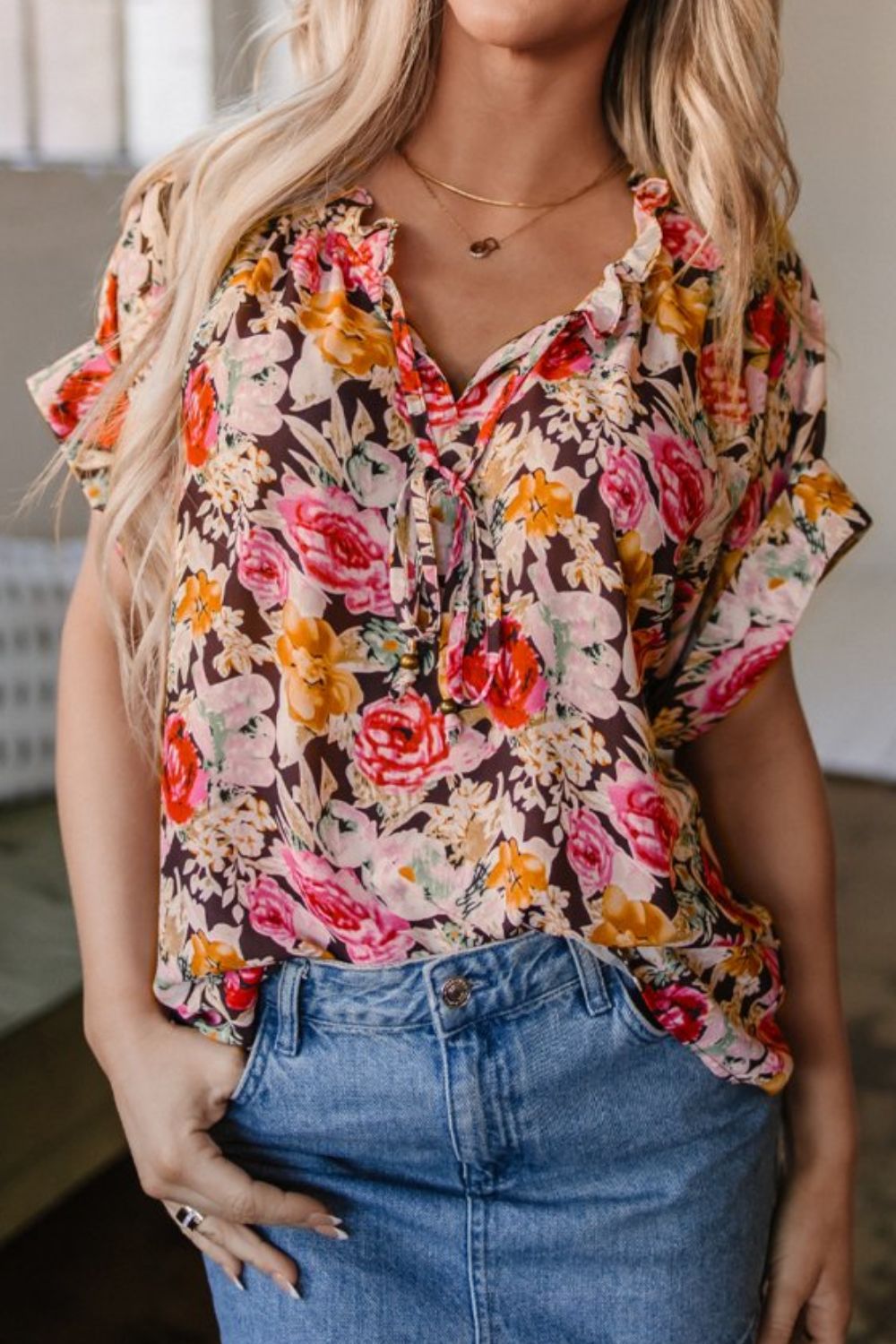 Floral tie neck short sleeve blouse with frill.