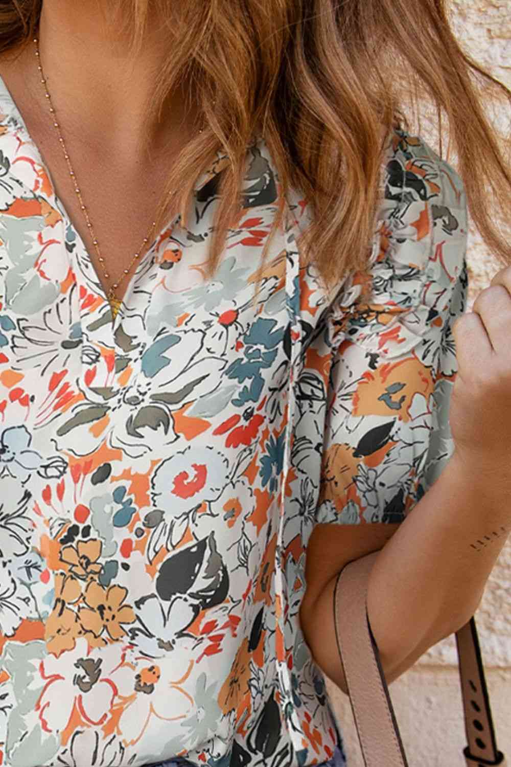 Floral tie neck shoulder detail blouse.