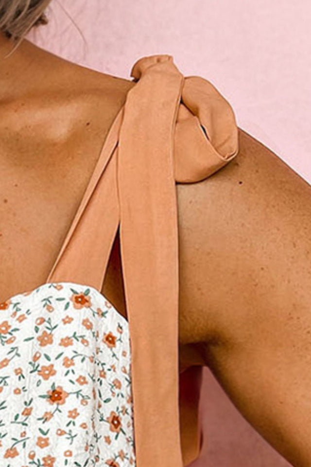 Floral print babydoll cami with tie-shoulders.