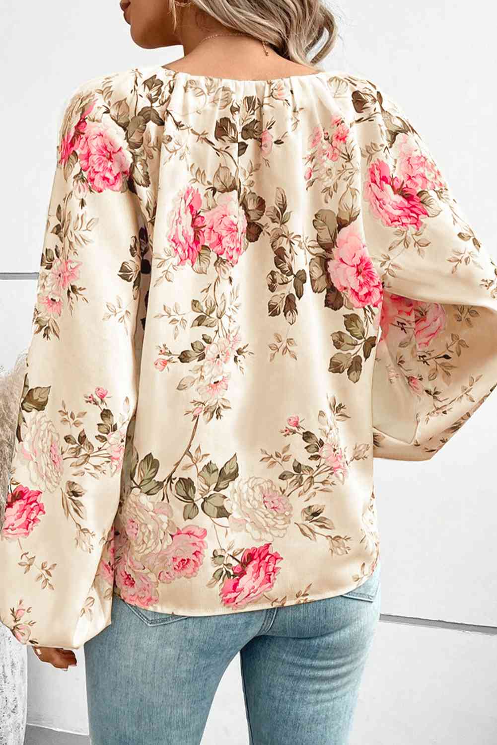 Floral V-neck balloon sleeve blouse.