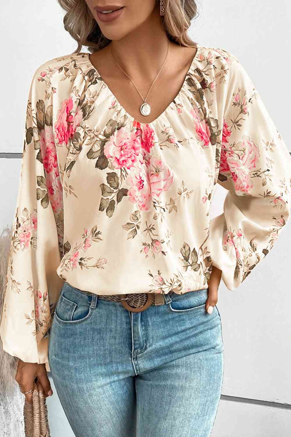 Floral V-neck balloon sleeve blouse.
