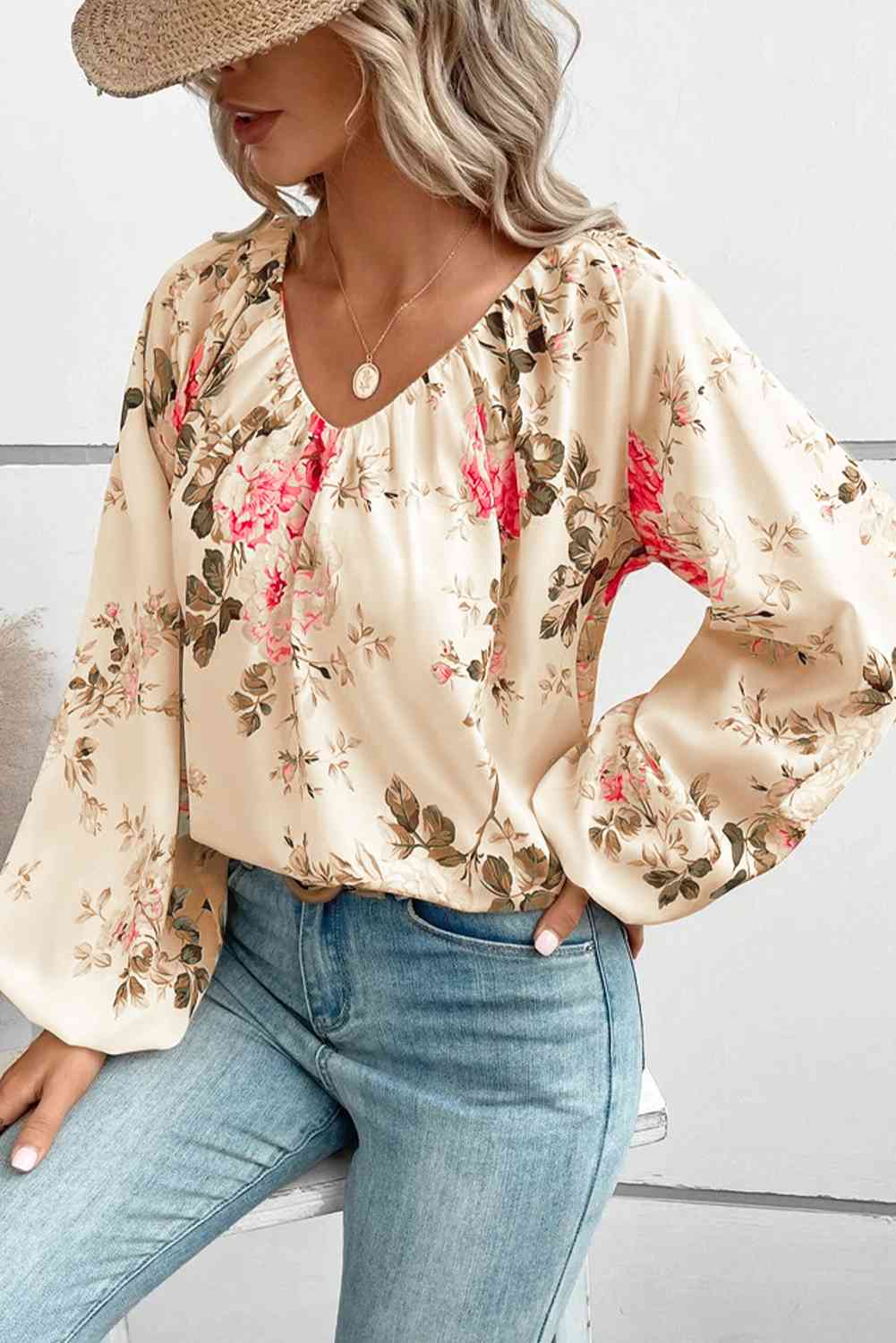 Floral V-neck balloon sleeve blouse.